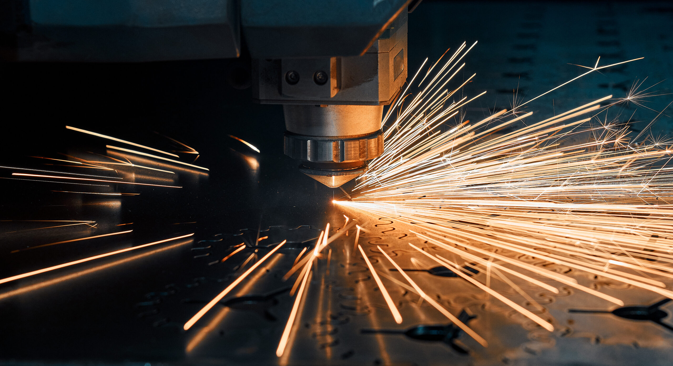 laser cutting company - an image of a sparking laser cutting metal in a metal fabrication company